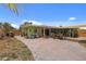 View of backyard with patio and verdant green space, offering a private oasis for recreation and relaxation at 5353 Starwood Pl, Sarasota, FL 34232