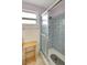 Tiled bathroom featuring a shower with glass doors and a bright window offering natural light at 5353 Starwood Pl, Sarasota, FL 34232