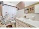 Bathroom featuring floral shower curtain, tile backsplash, and neutral paint at 5353 Starwood Pl, Sarasota, FL 34232