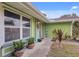Close up shot of the front of the home with colorful, decorative flower pots and a purple front door at 5353 Starwood Pl, Sarasota, FL 34232