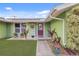 Close up shot of the front porch featuring colorful decor and a purple front door at 5353 Starwood Pl, Sarasota, FL 34232