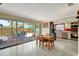 Bright kitchen with a dining area, stainless steel appliances, and sliding glass doors to the outdoor patio at 5353 Starwood Pl, Sarasota, FL 34232