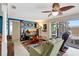 Comfortable living room featuring neutral tones, with a large TV, a ceiling fan and plenty of seating at 5353 Starwood Pl, Sarasota, FL 34232