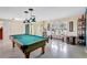 Open floor plan with pool table and large window letting in natural light at 5353 Starwood Pl, Sarasota, FL 34232