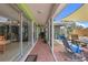 Enclosed patio featuring tile flooring, furniture, grill, and access to main living areas at 5353 Starwood Pl, Sarasota, FL 34232