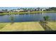 View of the backyard with a lake, a fence and community houses on the other side of the lake at 5521 Summit Gln, Bradenton, FL 34203