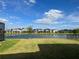 Beautiful lake view from the backyard of a home in a residential community on a sunny day at 5521 Summit Gln, Bradenton, FL 34203