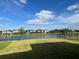 Beautiful lake view from the backyard of a home in a residential community on a sunny day at 5521 Summit Gln, Bradenton, FL 34203