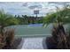 Outdoor basketball court with palm trees and landscaping with playing in the background at 5521 Summit Gln, Bradenton, FL 34203