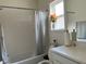 Bathroom featuring a shower/tub combo, a window and a white single sink vanity with framed mirror at 5521 Summit Gln, Bradenton, FL 34203