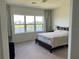 Bedroom with a lake view, a large window, and carpet flooring providing a bright, relaxing ambiance at 5521 Summit Gln, Bradenton, FL 34203