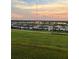 Community view of homes near a lake at sunset, as seen from a grassy overlook at 5521 Summit Gln, Bradenton, FL 34203