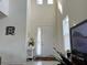 Bright foyer featuring high ceilings, neutral walls, decorative accents, and a front door view at 5521 Summit Gln, Bradenton, FL 34203