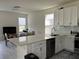 Bright, open kitchen with breakfast bar, white cabinetry, and modern appliances, great for entertaining at 5521 Summit Gln, Bradenton, FL 34203