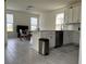 Open-concept kitchen featuring white cabinets, modern appliances, and a breakfast bar overlooking the living area at 5521 Summit Gln, Bradenton, FL 34203