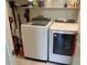 Well-organized laundry room with washer, dryer, shelving, and essential cleaning supplies at 5521 Summit Gln, Bradenton, FL 34203