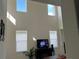 Bright open-concept living room featuring high ceilings, multiple windows, and neutral paint at 5521 Summit Gln, Bradenton, FL 34203