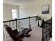 Cozy loft featuring a comfortable chair, ottoman and decorative railing with a tranquil sitting area at 5521 Summit Gln, Bradenton, FL 34203