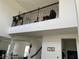 Loft area showcasing wrought iron railings, neutral walls, and views to the first floor at 5521 Summit Gln, Bradenton, FL 34203