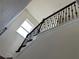 Staircase with decorative wrought iron railing and natural light from nearby window at 5521 Summit Gln, Bradenton, FL 34203