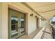 Charming balcony with an awning offers relaxing shade and views of neighborhood at 555 N Orange Ave # 307, Sarasota, FL 34236