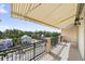 Inviting balcony with awning providing shade and views of the street at 555 N Orange Ave # 307, Sarasota, FL 34236