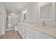 Well-lit bathroom features double sinks, stone countertops, and a glass shower at 555 N Orange Ave # 307, Sarasota, FL 34236