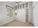 This bedroom features wood floors, a window and a built-in Murphy bed with shelving at 555 N Orange Ave # 307, Sarasota, FL 34236