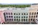 Aerial shot of multi-story building with balconies, awnings and parking lot at 555 N Orange Ave # 307, Sarasota, FL 34236
