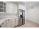 Open kitchen design featuring stainless steel refrigerator, quartz countertops and white cabinetry at 555 N Orange Ave # 307, Sarasota, FL 34236