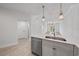 Modern kitchen featuring stainless steel appliances, quartz countertops, and stylish pendant lighting at 555 N Orange Ave # 307, Sarasota, FL 34236