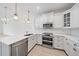 Beautiful kitchen boasts stainless steel appliances, quartz countertops, and sleek white cabinetry at 555 N Orange Ave # 307, Sarasota, FL 34236
