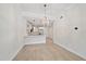 Contemporary living space with white walls, hardwood floors and a peek into the kitchen at 555 N Orange Ave # 307, Sarasota, FL 34236