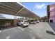 This image shows covered parking spaces with several parked cars at 555 N Orange Ave # 307, Sarasota, FL 34236