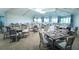 Elegant event space with tables set for a special occasion with large windows providing ample natural light at 5685 Palmer Cir # 204, Lakewood Ranch, FL 34211