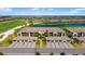 An aerial view of community homes with attached garages, tropical trees, and landscaping at 5685 Palmer Cir # 204, Lakewood Ranch, FL 34211