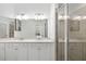 Elegant bathroom with double sinks, white cabinets and a glass-enclosed shower at 5685 Palmer Cir # 204, Lakewood Ranch, FL 34211