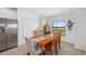 Inviting dining area with a wooden table, six chairs, and a scenic window view at 5685 Palmer Cir # 204, Lakewood Ranch, FL 34211