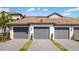 Attached garages with gray doors and tile roofs, offering convenient parking for residents at 5685 Palmer Cir # 204, Lakewood Ranch, FL 34211