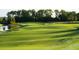 Lush green golf course view, including sand traps, and water feature at 5685 Palmer Cir # 204, Lakewood Ranch, FL 34211