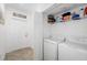 Convenient laundry room with a washer, dryer, and storage shelves for organization at 5685 Palmer Cir # 204, Lakewood Ranch, FL 34211