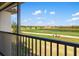Scenic view from the balcony overlooking the lush green golf course and tranquil water feature at 5685 Palmer Cir # 204, Lakewood Ranch, FL 34211