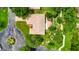 Bird's eye view of a home, lush landscaping, and circular driveway and nearby cul-de-sac at 5705 Garden Lakes Majestic, Bradenton, FL 34203