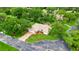 Stunning aerial view of a well-manicured home featuring a brick driveway and beautiful landscaping at 5705 Garden Lakes Majestic, Bradenton, FL 34203