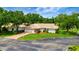 Aerial view of a home showcasing a tile roof, landscaped yard, and paved driveway at 5705 Garden Lakes Majestic, Bradenton, FL 34203