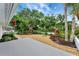 The home features a landscaped backyard with gravel, stone accents, and tropical plants at 5705 Garden Lakes Majestic, Bradenton, FL 34203