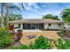 The backyard features landscaping, a screened patio, and room for outdoor entertaining at 5705 Garden Lakes Majestic, Bradenton, FL 34203