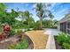 Beautifully landscaped backyard with gravel and stone accents surrounded by tropical plants at 5705 Garden Lakes Majestic, Bradenton, FL 34203