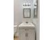 Elegant bathroom featuring a gray vanity with a white countertop and framed mirror at 5705 Garden Lakes Majestic, Bradenton, FL 34203
