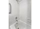 Clean white bathtub and shower area with grab bar and tiled surround at 5705 Garden Lakes Majestic, Bradenton, FL 34203
